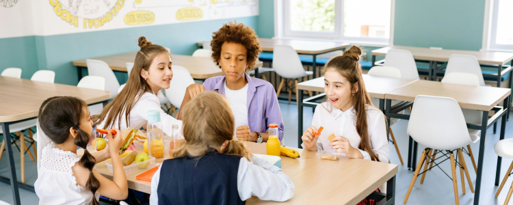 Pupils eating lunch in classroom